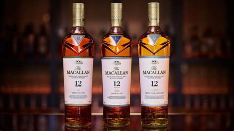 Macallan whisky bottles lined up on a wooden bar showing clear age statements and cask details on each label